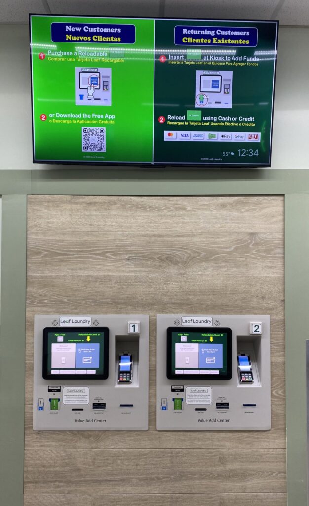 Payment kiosks with instructions on TV screen above